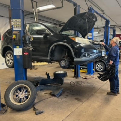 auto shop near liverpool ny thumbnail image of first automotive technician working on open hood car